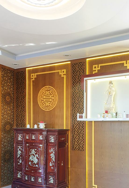 Vách ốp gỗ phòng thờ với hoa văn trang trí và đường đèn viền