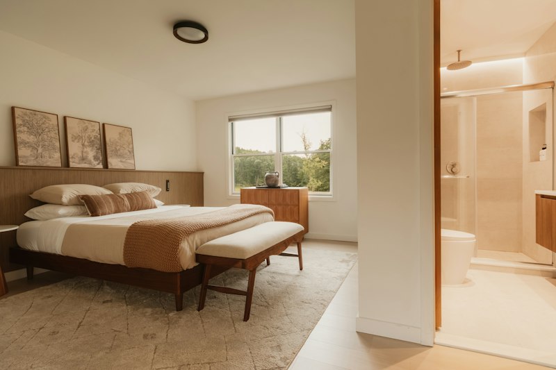 Hotel room with a wood bed, a paneled headboard wall and a wood wardrobe